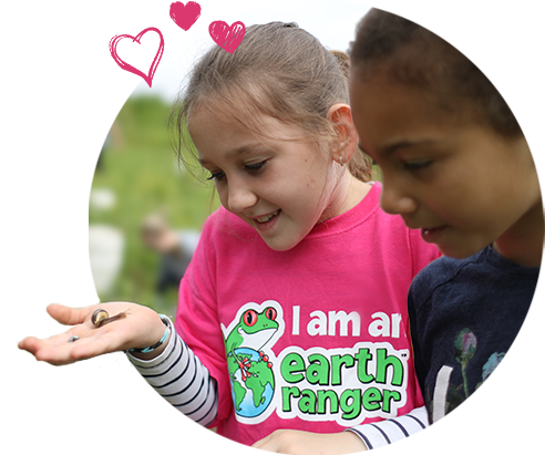 2 Earth Rangers holding a snail 2 Earth Rangers holding a snail
