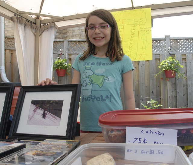 Mady at her yard sale for the American Badger