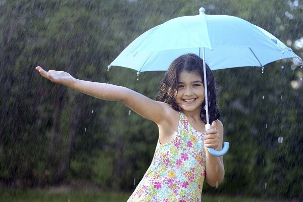 young girl enjoying the rain