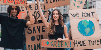 Climate activist holding up signs