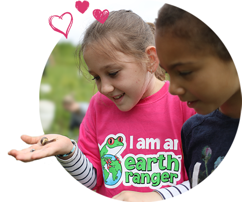 2 Earth Rangers holding a snail