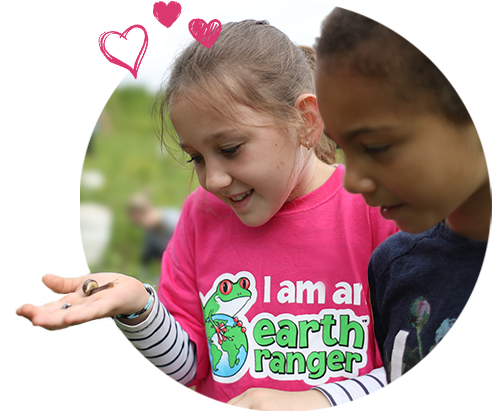2 Earth Rangers holding a snail 2 Earth Rangers holding a snail