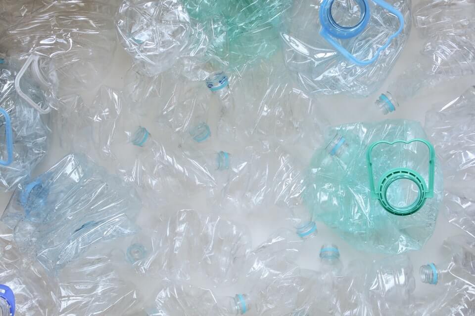 a pile of crumpled plastic water bottles